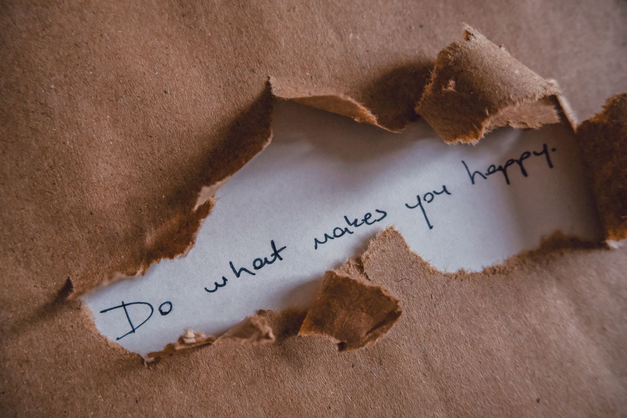 our-story-01 Brown paper revealing message 'Do what makes you happy.'