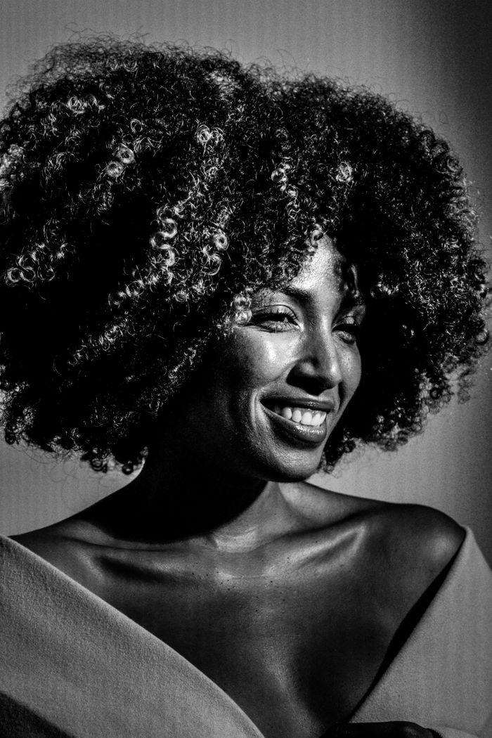 test-02 A striking black and white portrait of a woman with curly hair, exuding confidence and elegance.